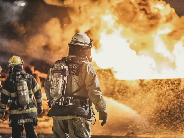 Firefighters in breathing apparatus tackling a large fire