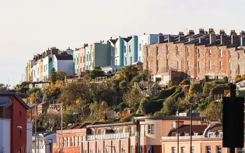 A row of colourful terraced houses on a hillside in Bristol