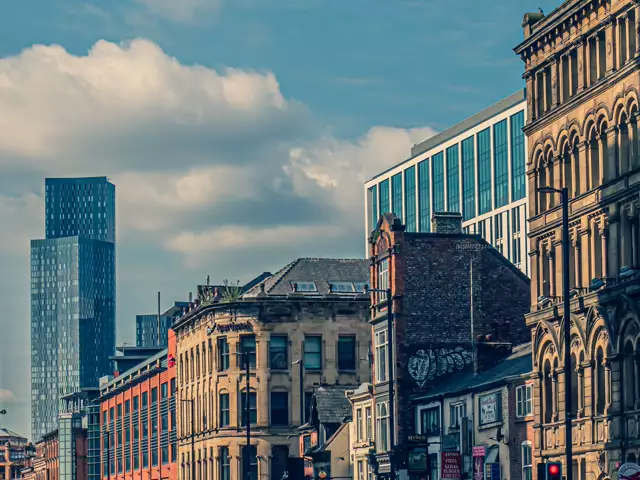 A Manchester street with Victorian buildings and modern towers