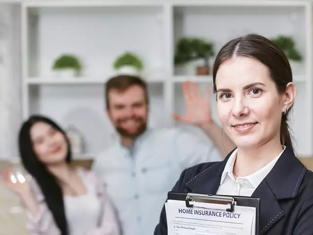 A smiling female adviser holding a policy document