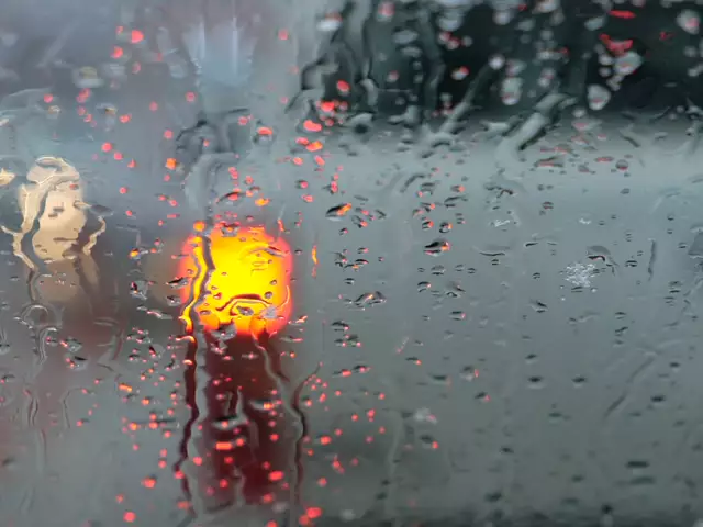 Heavy rain running down a window during a storm